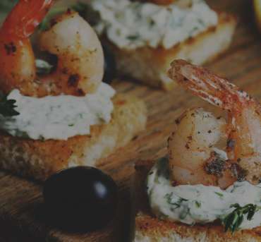 A close up of some shrimp and cheese on bread
