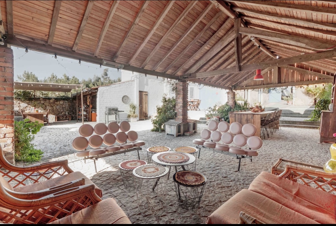 A patio with many chairs and tables in it